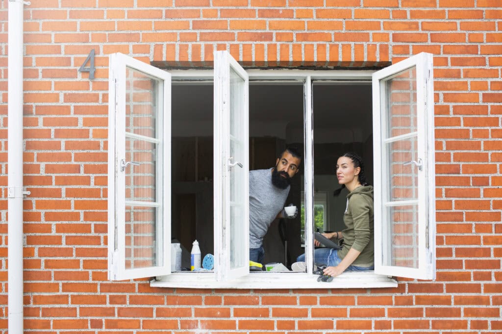 Couple looking through their new replacement windows in Whitstable